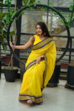 Premium Yellow Half Silk Nakshi Paar Saree with Blue & Purple Border | Festive & Party Wear (Without Blouse Piece) - Image 2